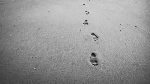 High angle view of footprints on sand