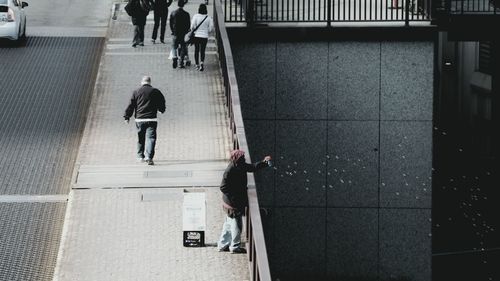 High angle view of person blowing bubbles on bridge