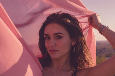 Portrait of beautiful woman holding scarf