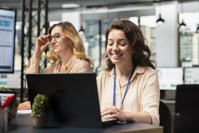 Businesswoman using laptop at table