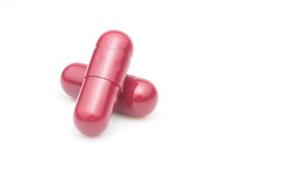 High angle view of pink petals on white background