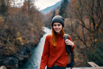 Young woman standing in park during winter