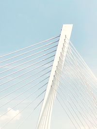 Low angle view of bridge against buildings against clear sky