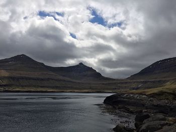 Scenic view of mountains against cloudy sky