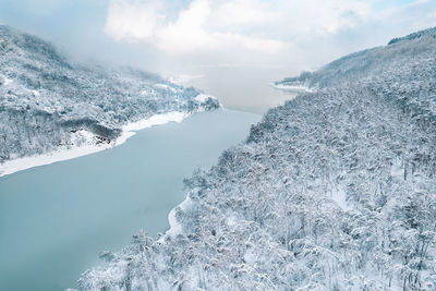 Aerial view of lake and mountain forest in winter