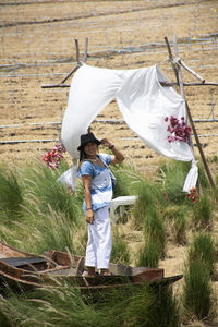 Rear view of boy standing on field