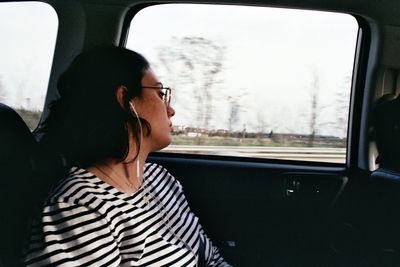 Rear view of woman sitting in car