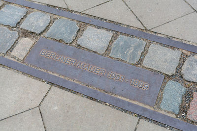 High angle view of text on footpath