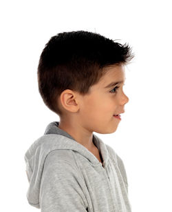 Portrait of boy looking away against white background