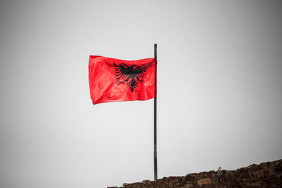 Low angle view of flag against clear sky