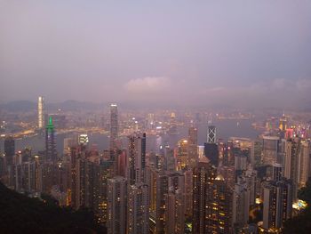 Aerial view of illuminated buildings in hongkong city against sky