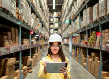 Portrait of young woman using smart phone in box