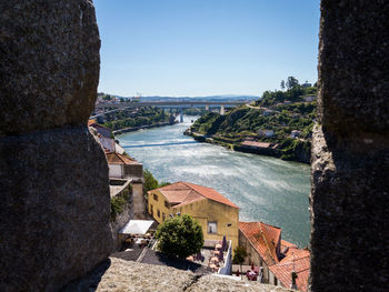 High angle view of buildings by sea against clear sky