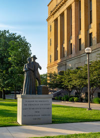 Statue in park against sky