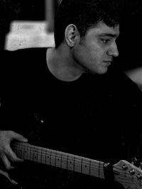 Portrait of young man playing guitar