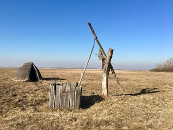 Metallic structure on field against clear sky