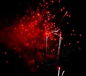 Low angle view of firework display at night