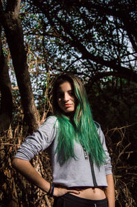 Portrait of young woman looking away in forest