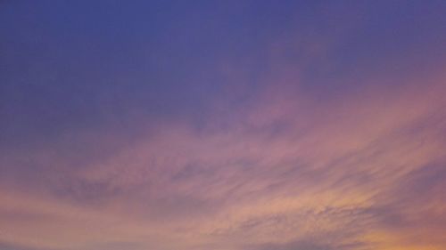 Low angle view of cloudy sky at sunset