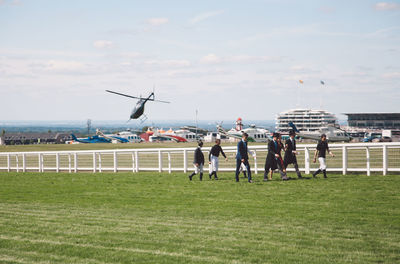 People on field against sky