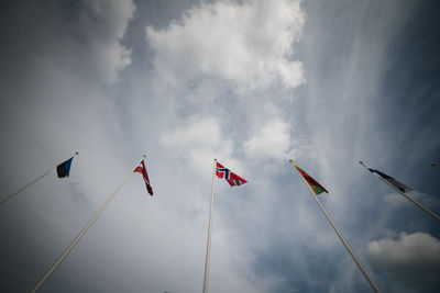 Low angle view of flags against sky