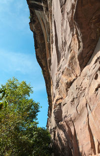 Low angle view of rock formation against sky