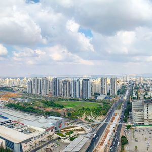 High angle view of street amidst buildings against sky