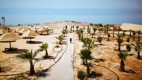 Man walking on a footpath directed to the sea. dead sea, jordan.