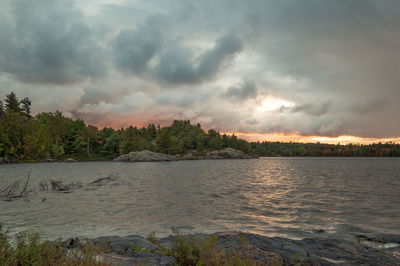 Scenic view of calm sea against cloudy sky