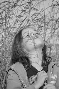 Portrait of woman standing against plants