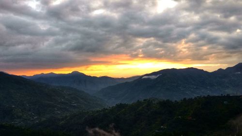 Scenic view of mountains against dramatic sky