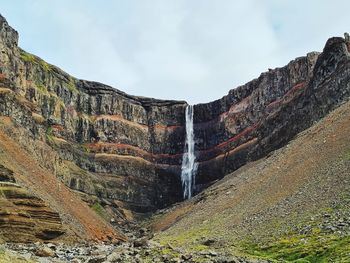 Low angle view of waterfall against sky