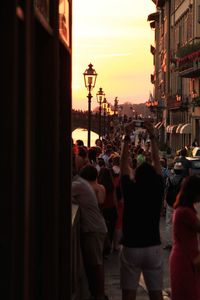 People on street ponte vecchio during sunset