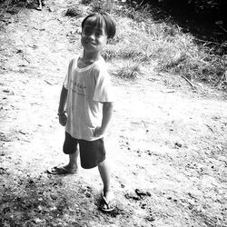 Full length of boy standing on railing