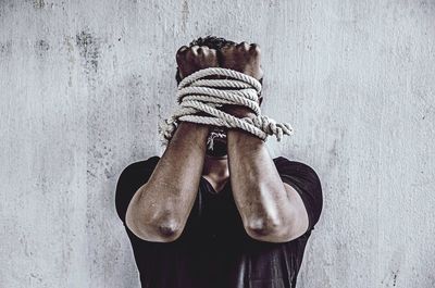 Close-up of man tied up