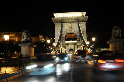 Illuminated bridge against sky at night