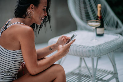 Midsection of man using mobile phone