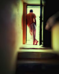 Low section of woman standing in corridor