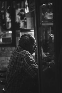 Rear view of man on street in city at night