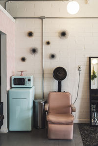 Empty chair against wall in hair salon