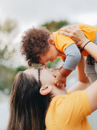 Smiling mother and son embracing outdoors