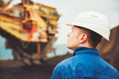 Mid adult man standing at construction site