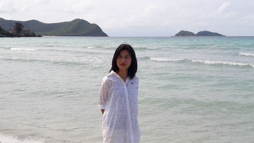 Portrait of woman standing on beach