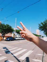 Close-up of person gesturing in city