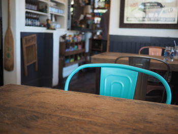 Chair by wooden table at restaurant