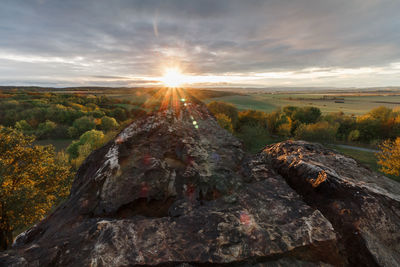 Scenic view of rocks against sky during sunset