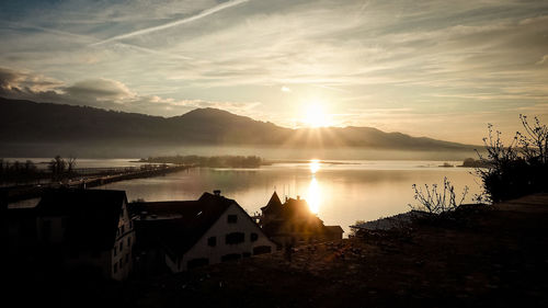 Scenic view of lake against sky during sunset