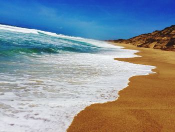 Scenic view of beach against clear sky