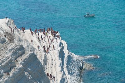 High angle view of people on scala dei turchi by sea