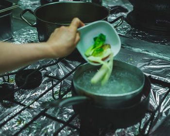 Cropped image of person preparing food in kitchen